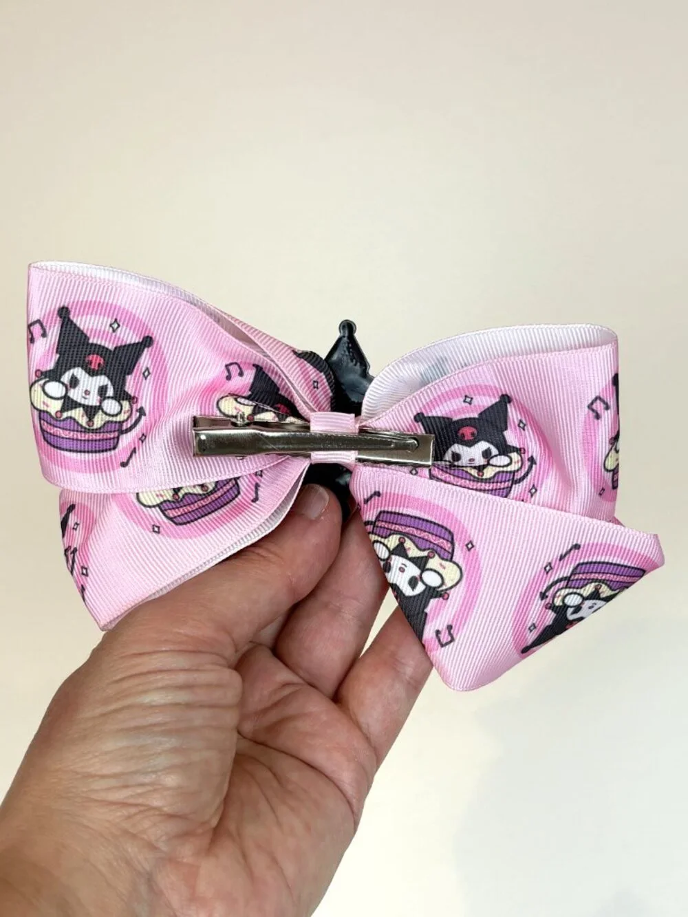 Cute pink Sanrio hair bow featuring Kuromi and an all-over Kuromi pattern. New